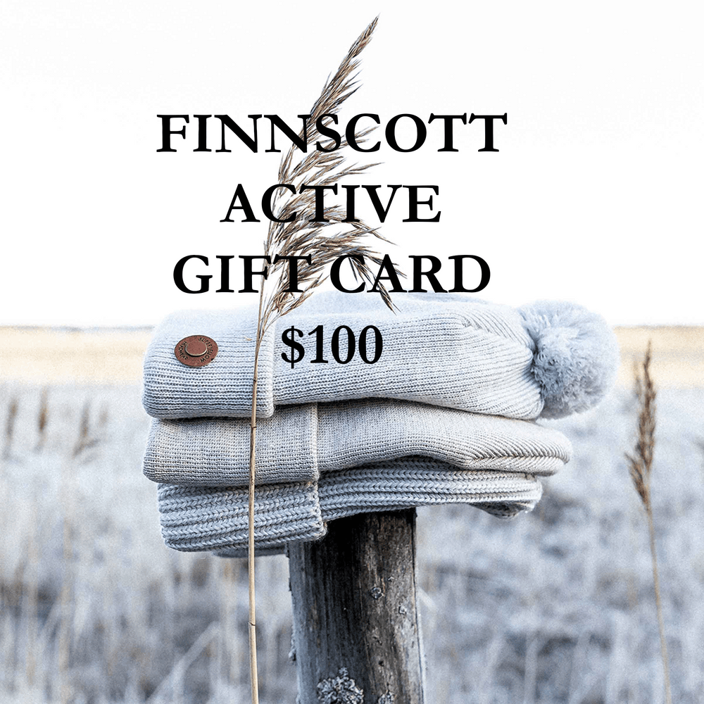 Stack of grey beanies on a wooden post with 'FINNSSCOTT ACTIVE GIFT CARD $100' text against a blurred natural background.