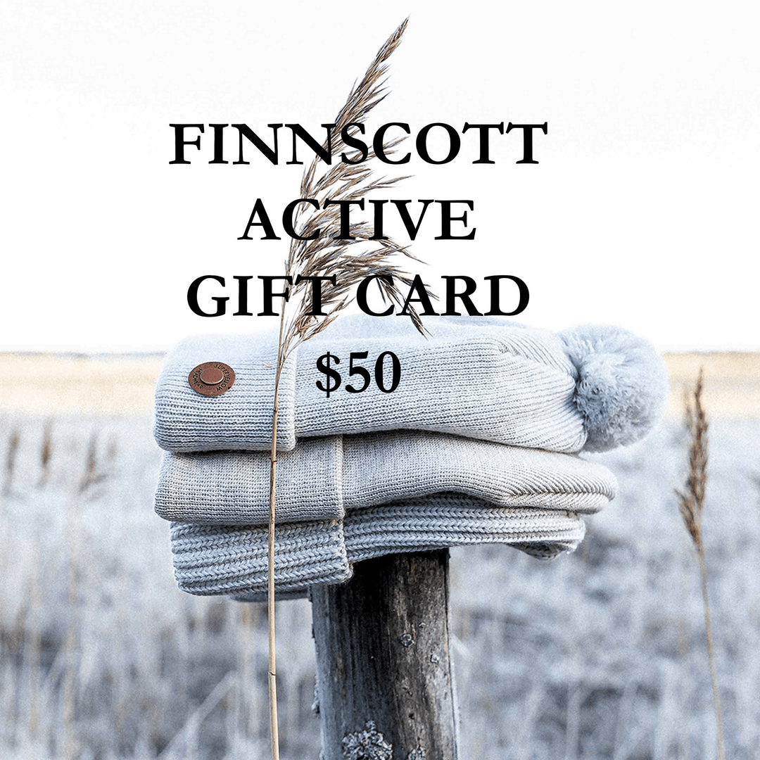 Stack of gray knit beanies with a $50 value on a wooden post against a blurred natural background, featuring the brand 'FINNSSCOTT'.